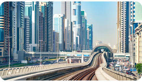Photo of the Metro rail in Dubai, sorrounded by skyscrapers on both sides of the rail.